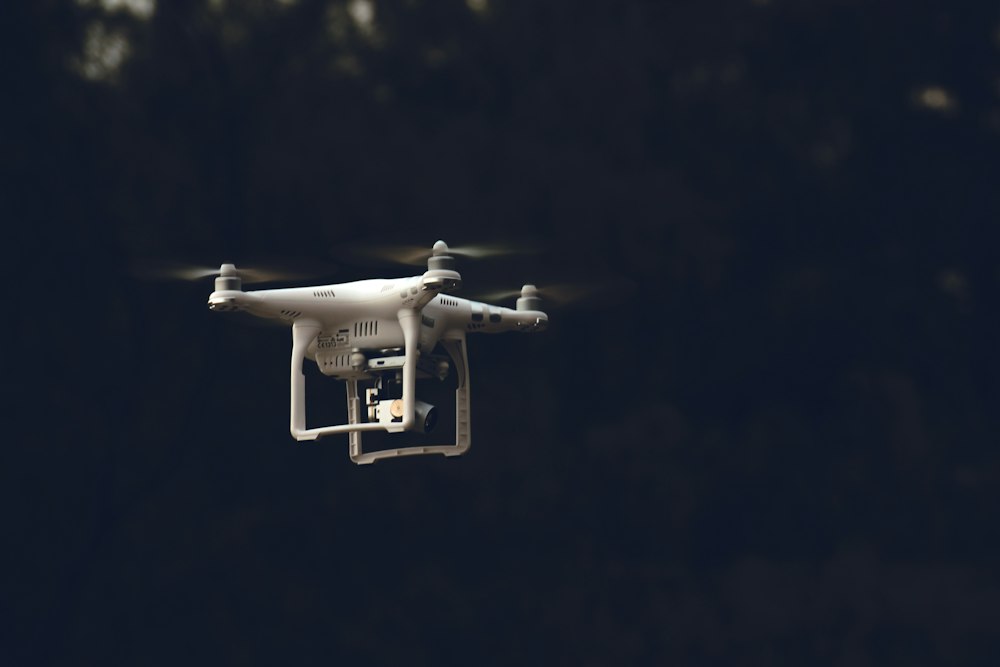 Drone flying against a dark sky